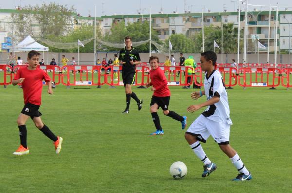 Zagueiro Marcelo Ajul sai jogando com a bola controlada enquanto  observado por adversrios.