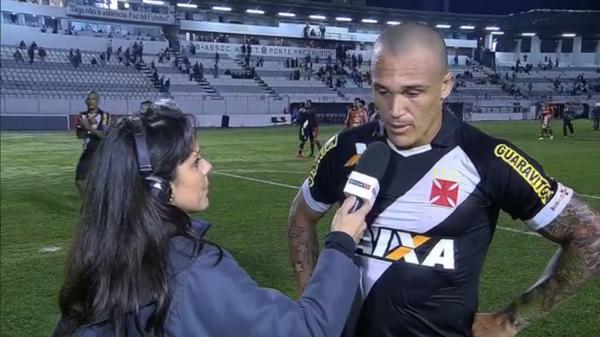 Rodrigo,  esquerda, faz sinal da Fora Jovem enquanto Leandro d entrevista